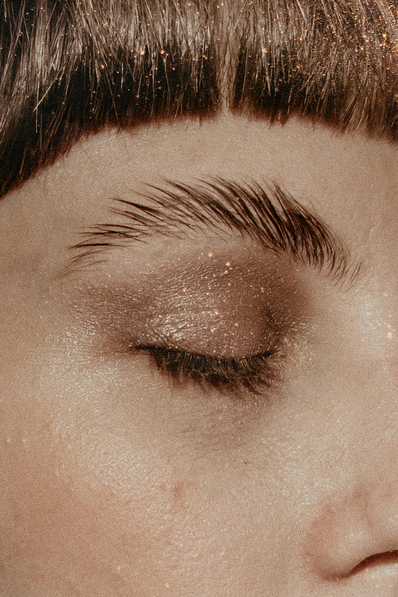 a close up of a woman's eye with glitter on it