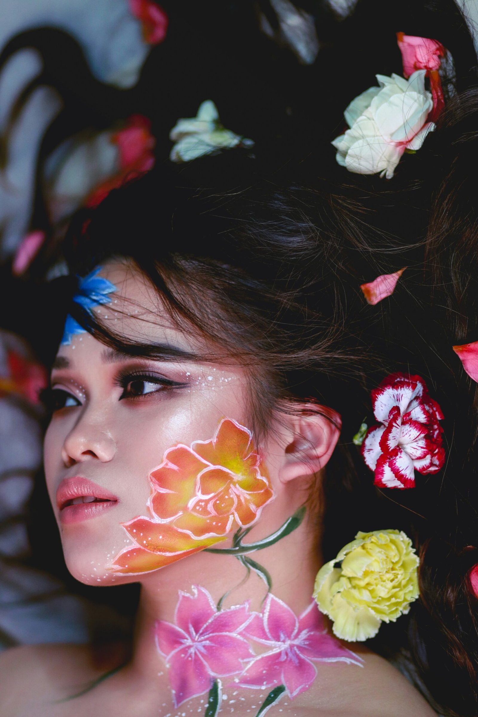 woman with red and white flower on her ear